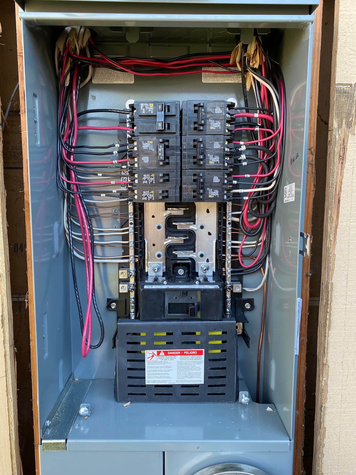 An electrical panel with the cover off, showing the wires inside.